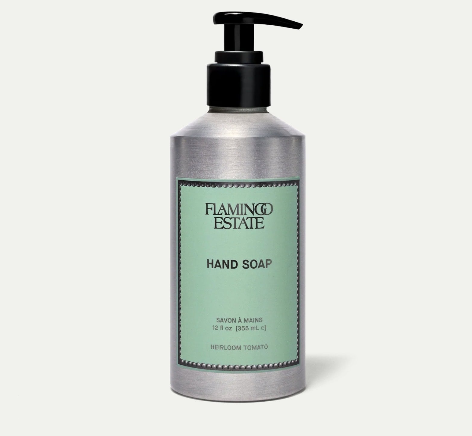 A silver pump bottle labeled “Flamingo Estate Hand Soap, Heirloom Tomato, 12 fl oz (354 ml)” against a plain background.