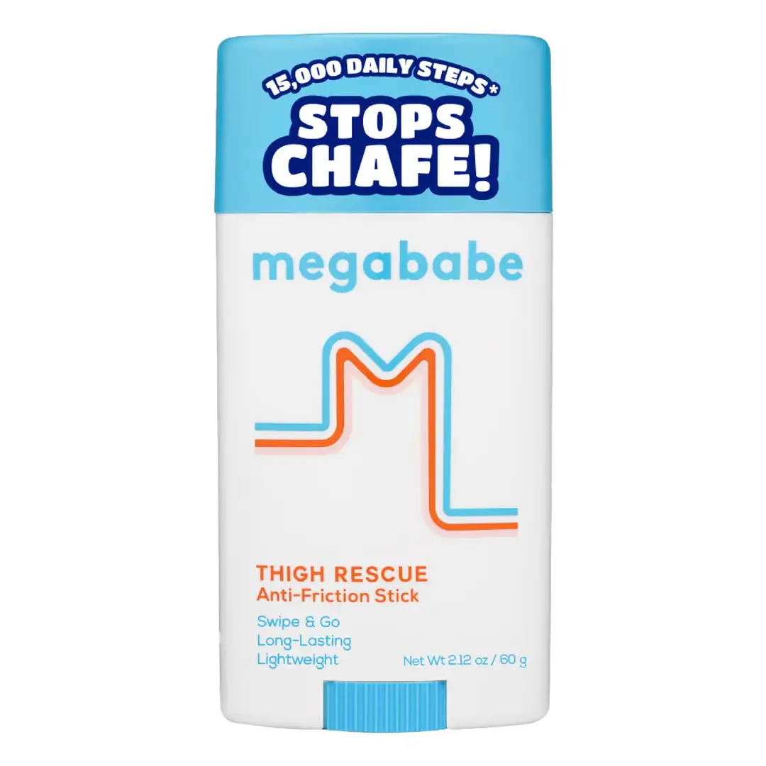 A white and blue stick labeled “megababe Thigh Rescue Anti-Friction Stick” with text “Stops Chafe!” and “15,000 Daily Steps” on the lid.